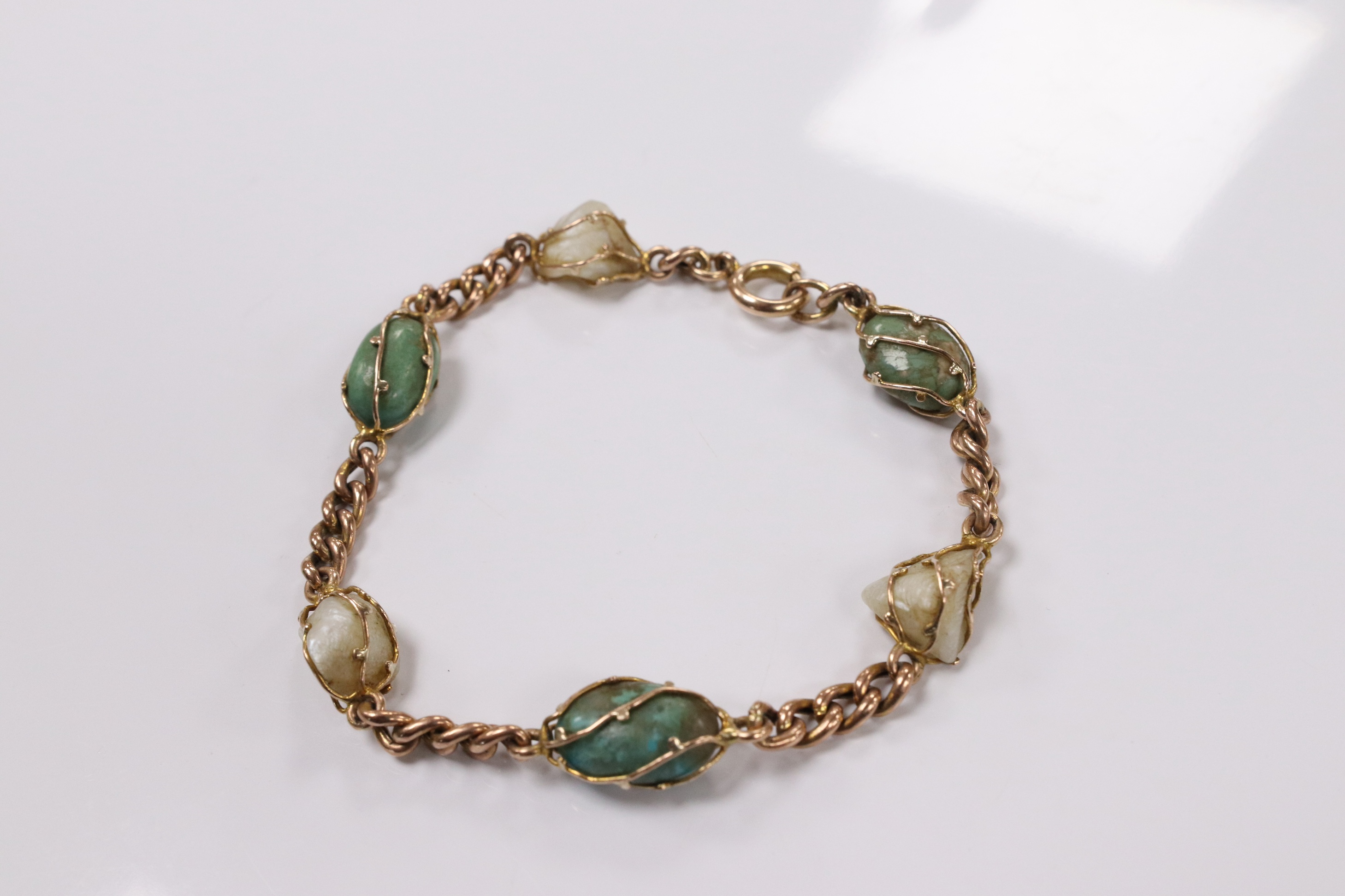 An early 20th century yellow metal, turquoise and baroque pearl set curb link bracelet, 18cm, gross weight 11.1 grams. Condition - fair